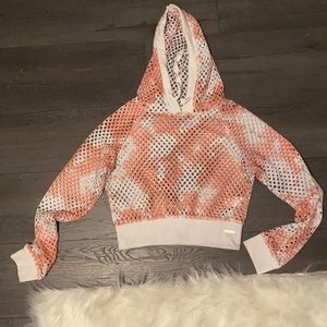 A mesh hoodie with orange and white tie-dye.